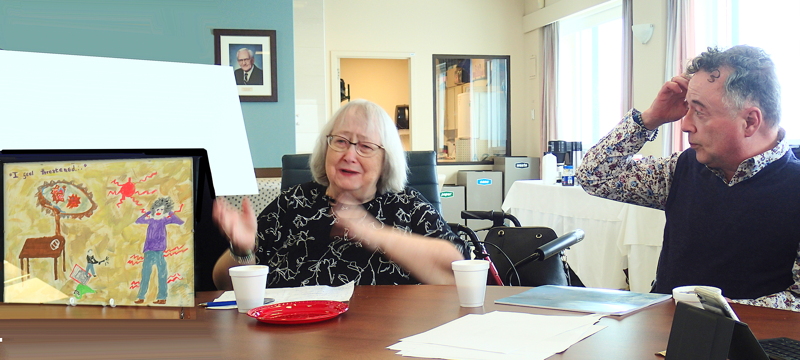 Lynn Murphy and Don Stevens look at one of Lynn's paintings