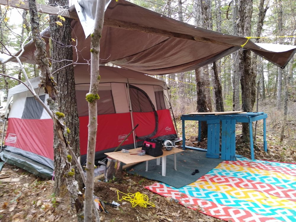 Campsite with canopy over the tent and cooking table.