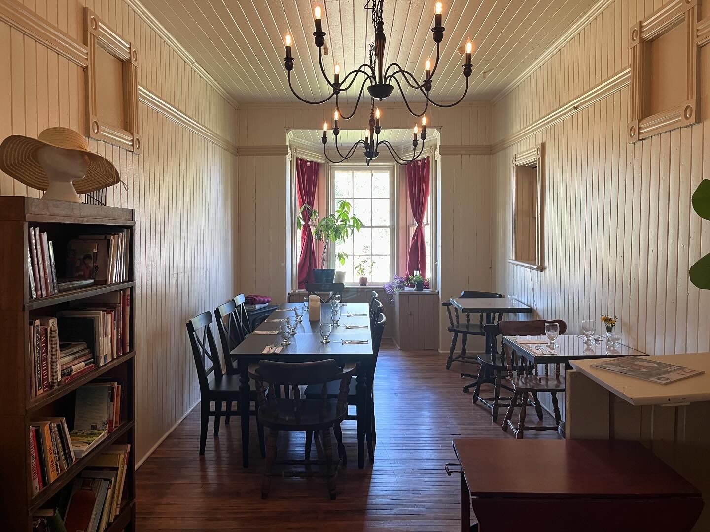 train station interior with dining table, chandelier and bookshelf