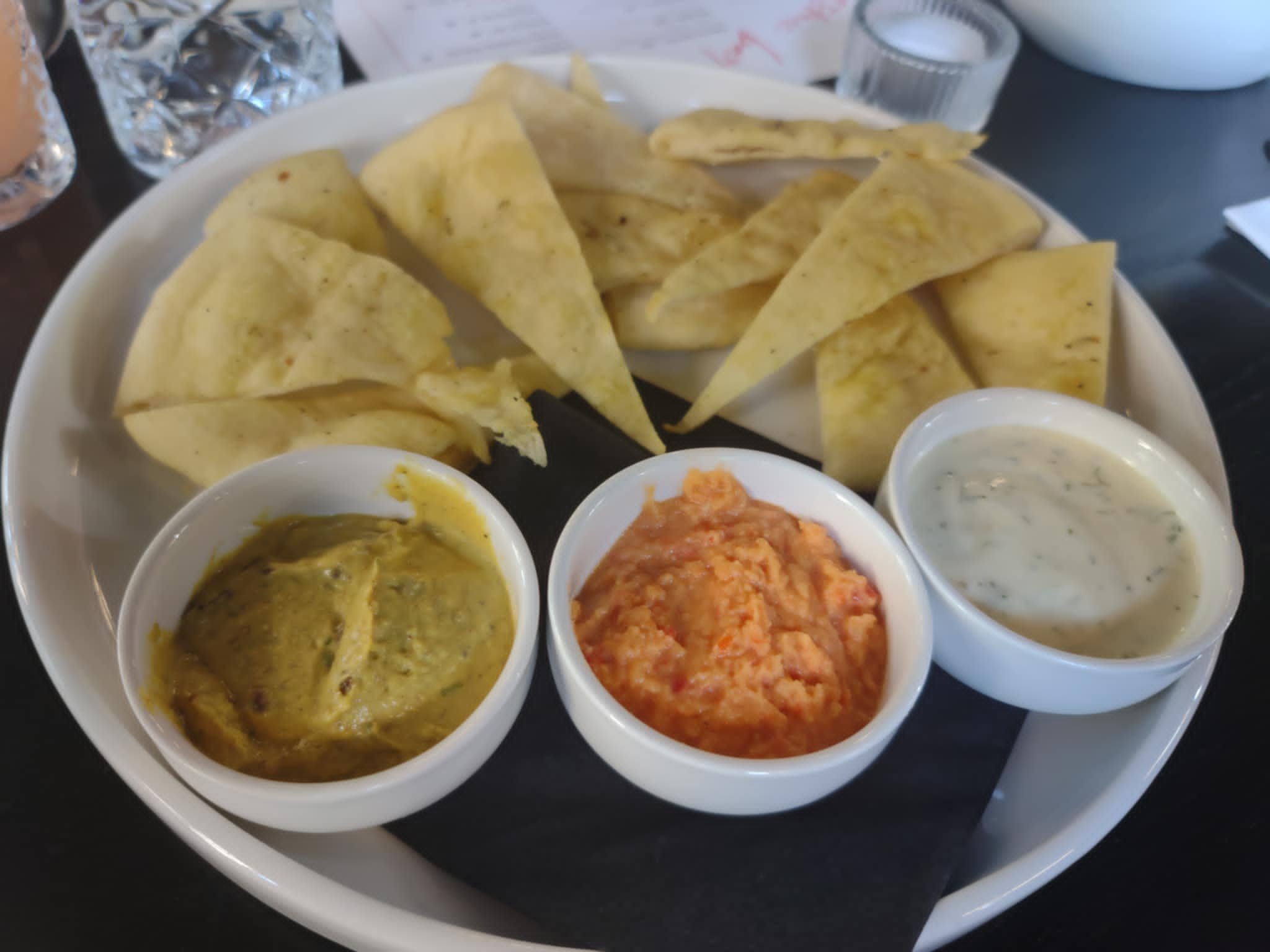 three dips in ramekins, and flat bread triangles