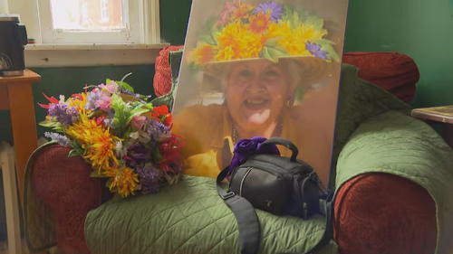 Painting of anita, and a camera bag containing ashes, and her hat that's in the painting