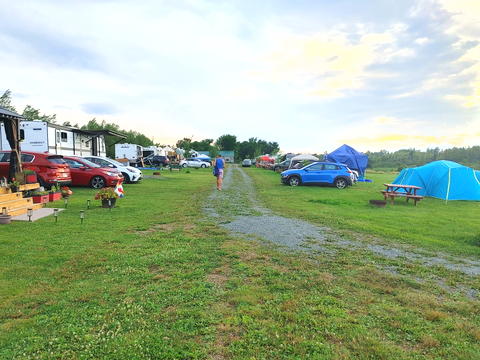 the "street" in a campground with tents on the right and trailers on the left