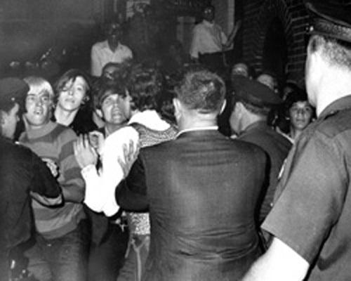 old photo taken from behind cops, we see the protester's faces